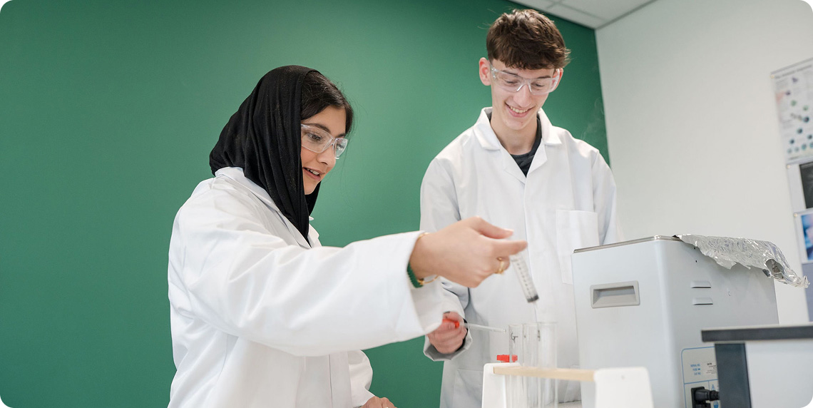 Students wearing white lab coat conducting and preparing experiments