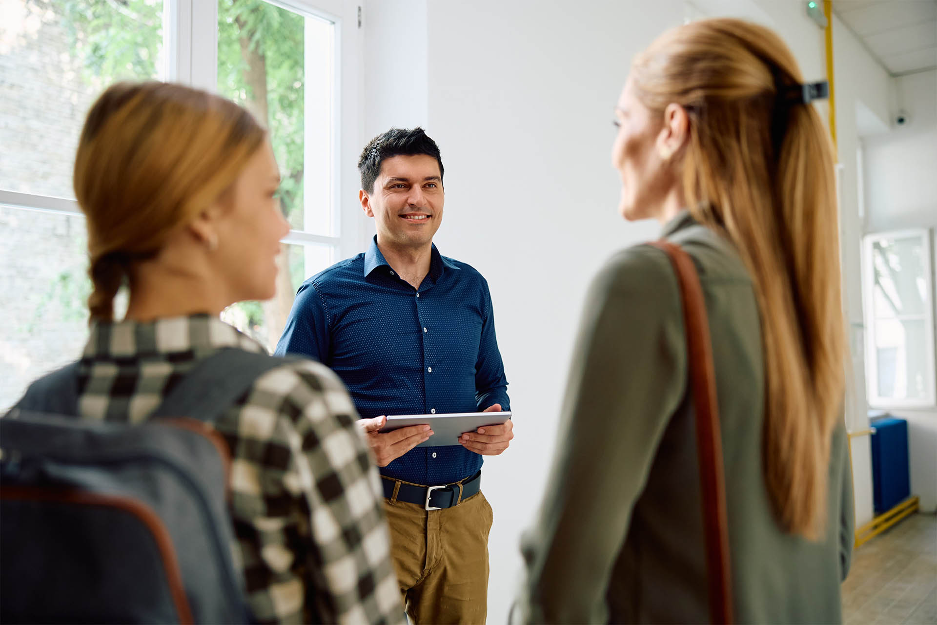 Tutor smiling talking to potential students