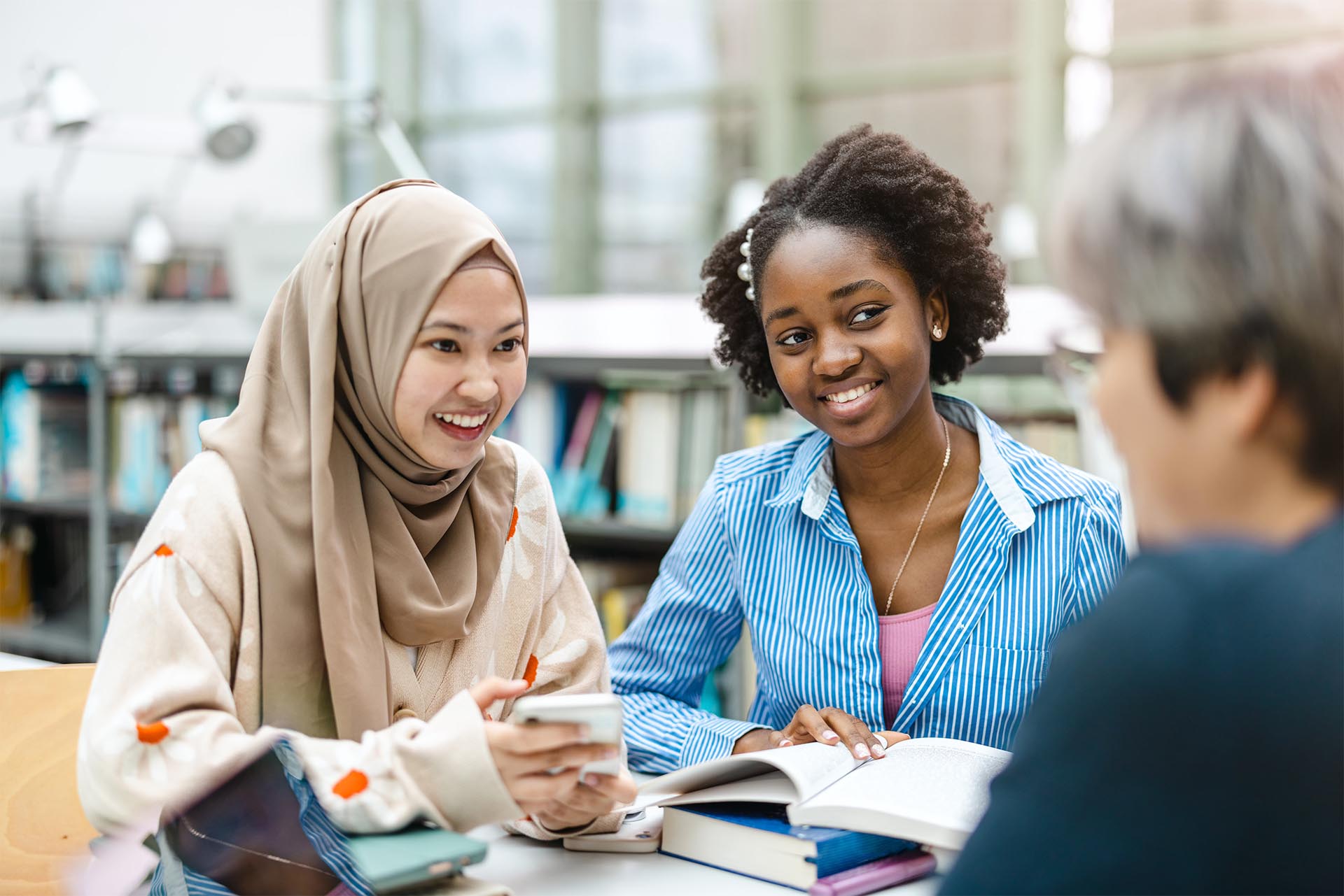 Students having cheerful conversation in the library