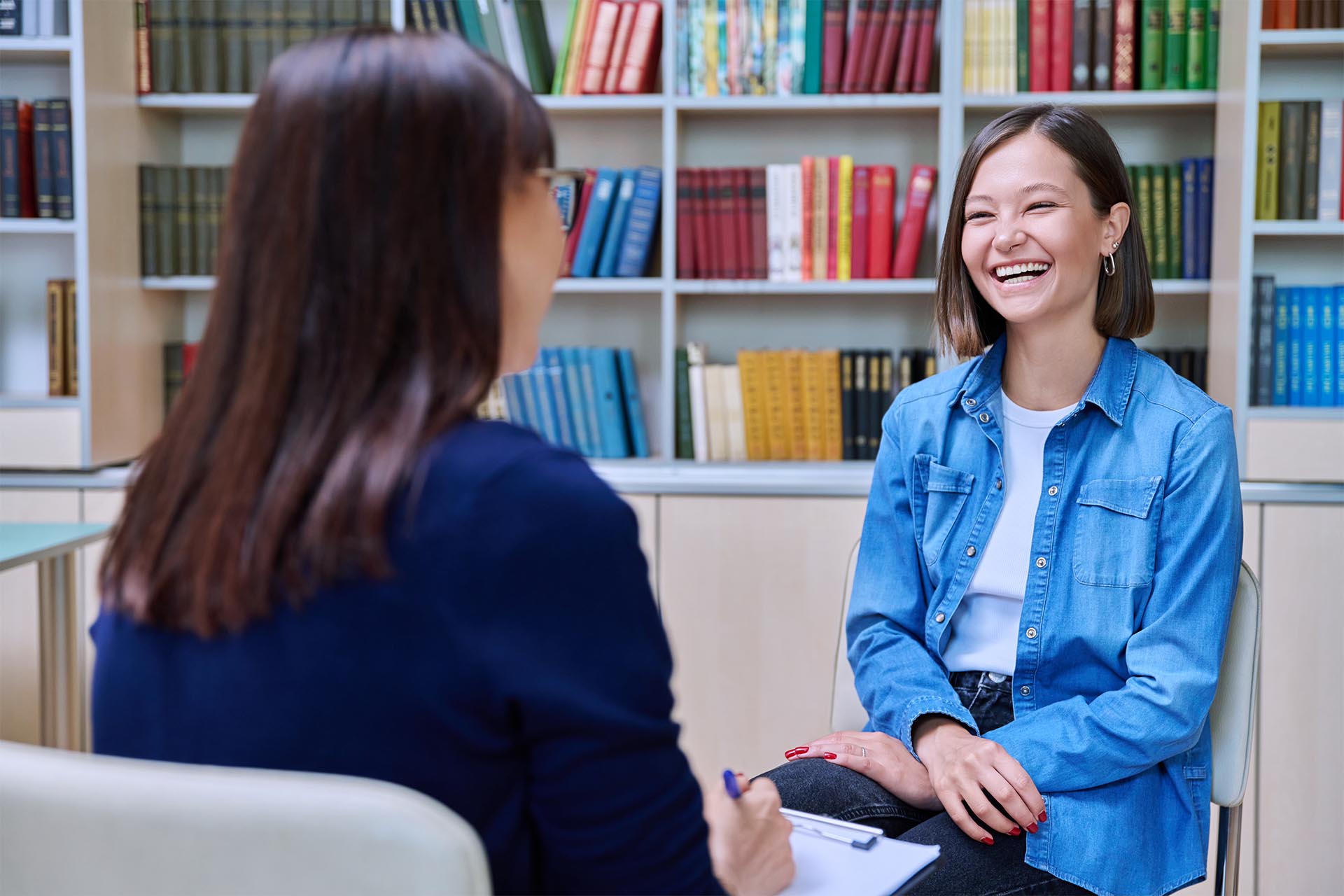 Students having cheerful conversation in the library