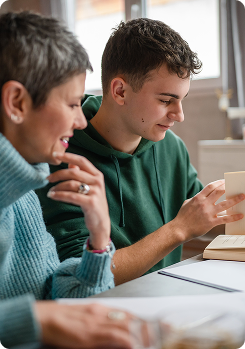 Tutor and student sitting together looking at notes