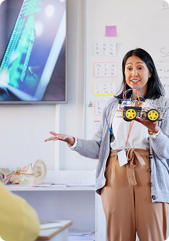 Tutor holding a test model giving lesson in the classroom