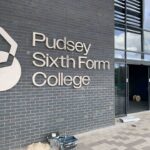 Brick building with sign reads Pudsey Sixth Form College and logo