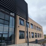 Two story brown building with brise soleil installed of Pudsey Sixth Form College