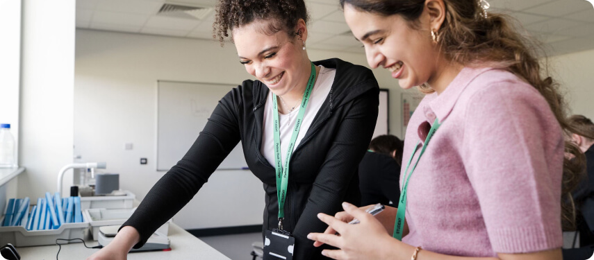 Cheerful students standing in lab looking at project