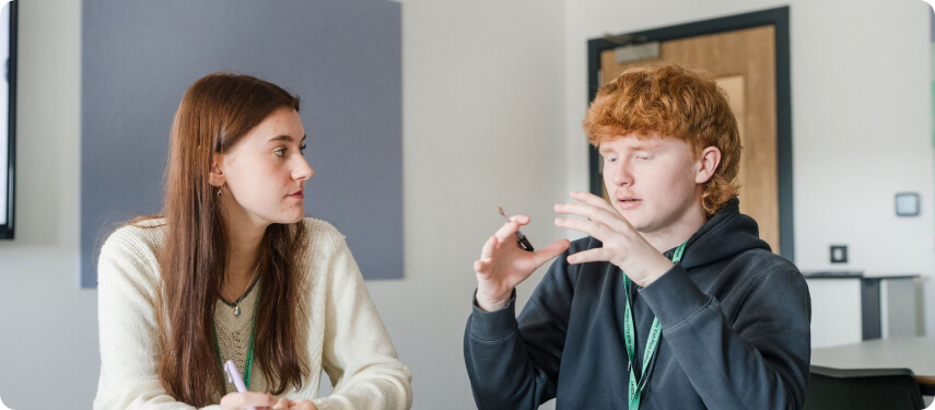 Students sitting down having discussion in the classroom