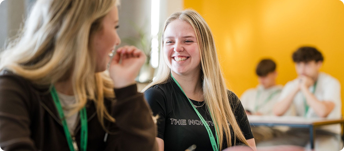 Students wearing black top talking in classroom
