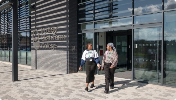Two students walking out from the front building of Pudsey Sixth Form College