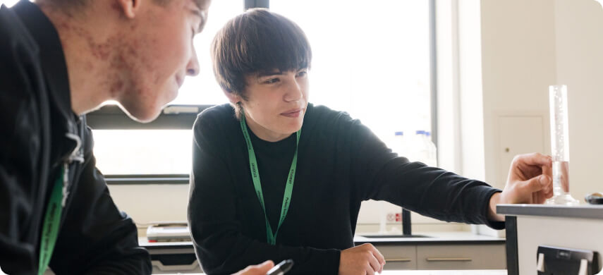 Student sitting down in lab conducting experiments